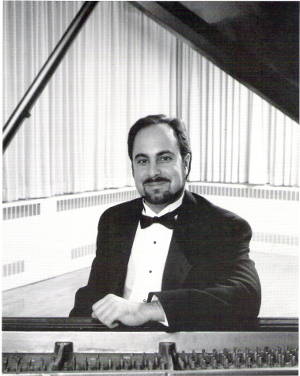 black and white press photo of Eric Charnofsky at the piano